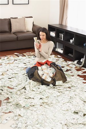 simsearch:640-01362961,k - Woman at Home with Pile of Money Stock Photo - Rights-Managed, Code: 700-01200177