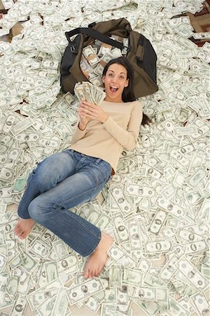 excited women holding money - Woman at Home with Pile of Money Stock Photo - Rights-Managed, Code: 700-01200182