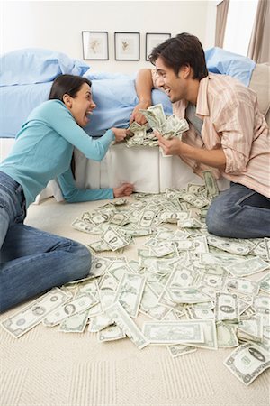 simsearch:640-01362961,k - Couple Stuffing Money in Mattress Stock Photo - Rights-Managed, Code: 700-01200207