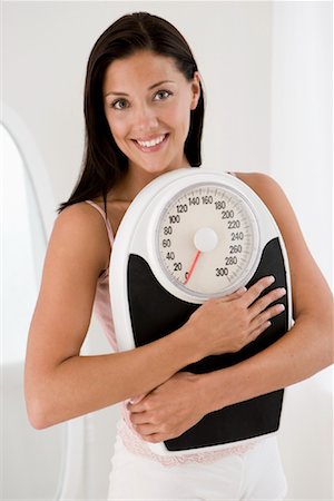 scales weight woman happy - Portrait of Woman Holding Scale Stock Photo - Rights-Managed, Code: 700-01224060