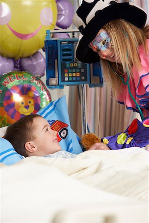 photo of a white boy on sick bed - Clown Examining Child in Hospital Bed Stock Photo - Rights-Managed, Code: 700-01224072