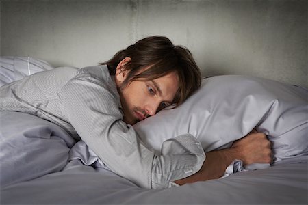 Man Lying on Bed Stock Photo - Rights-Managed, Code: 700-01223740