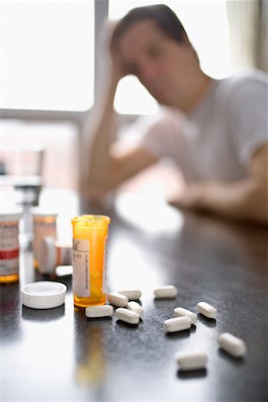 Man Looking at Pills on Table Stock Photo - Rights-Managed, Code: 700-01223937