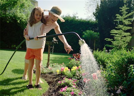 family backyard gardening not barbeque - Grandmother and Granddaughter Watering Plants Stock Photo - Rights-Managed, Code: 700-01234769