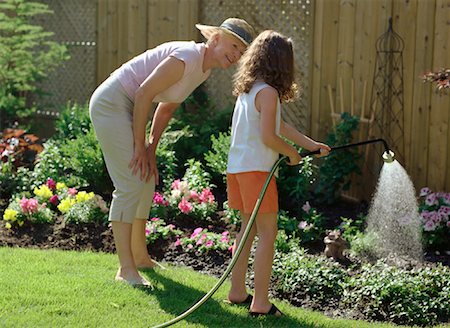 preteen girls bent over - Grandmother and Granddaughter Watering Plants Stock Photo - Rights-Managed, Code: 700-01234770