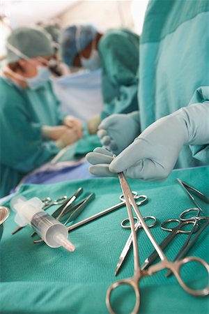 surgeon with bloody gloves - Doctors Performing Surgery Stock Photo - Rights-Managed, Code: 700-01234866