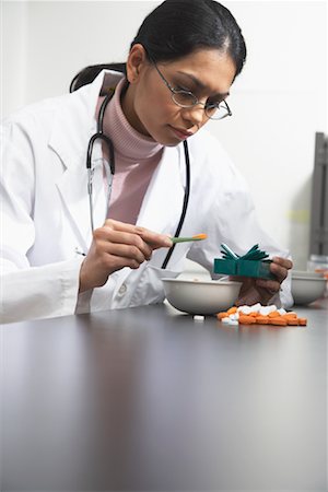 pictures of black women doctors at work - Doctor Looking at Pills in Lab Stock Photo - Rights-Managed, Code: 700-01235926