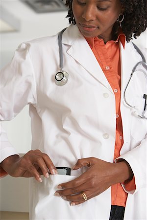 pictures of black women doctors at work - Doctor Putting PDA in Pocket Stock Photo - Rights-Managed, Code: 700-01236099