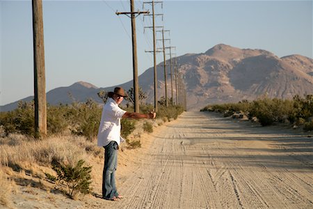 dirt road signs - Man Hitchiking on Dirt Road Stock Photo - Rights-Managed, Code: 700-01236365