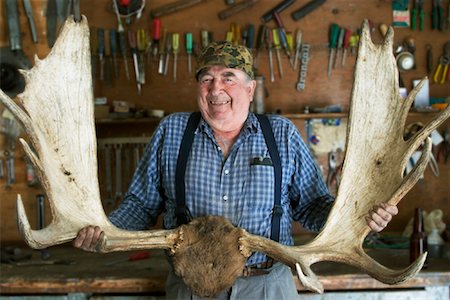 senior man garage - Man Holding Moose Antlers Stock Photo - Rights-Managed, Code: 700-01248050