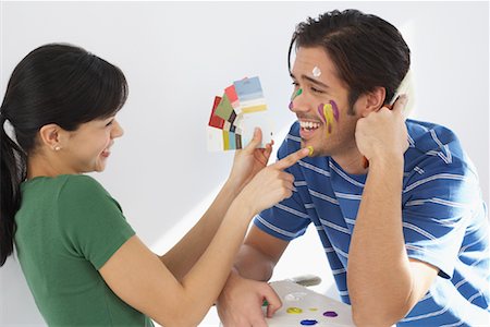 Woman Painting Man's Face Foto de stock - Con derechos protegidos, Código: 700-01249226