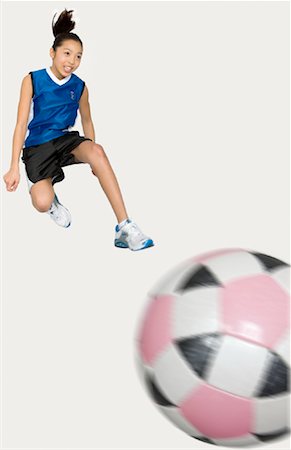 soccer teenage girls kick - Girl Jumping in Air Stock Photo - Rights-Managed, Code: 700-01259971