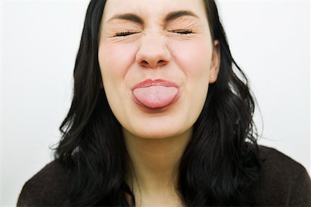 Woman Sticking Tongue Out Foto de stock - Con derechos protegidos, Código: 700-01260312