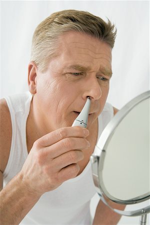 Man Trimming Nose Hair Stock Photo - Rights-Managed, Code: 700-01275145