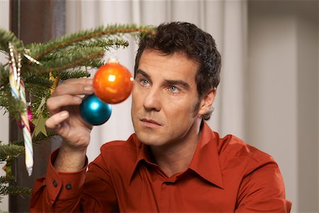 Man Decorating Christmas Tree Stock Photo - Rights-Managed, Code: 700-01296257