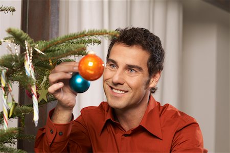 Man Decorating Christmas Tree Stock Photo - Rights-Managed, Code: 700-01296258