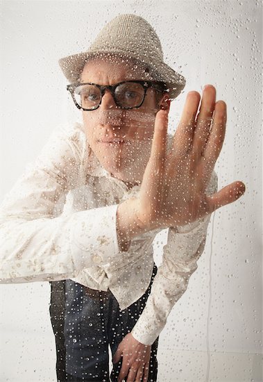 Man Looking Through Wet Glass Stock Photo - Premium Rights-Managed, Artist: Masterfile, Image code: 700-01296604