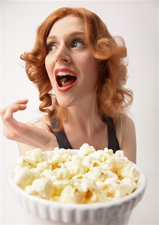 popcorn white background - Woman Eating Popcorn Stock Photo - Rights-Managed, Code: 700-01296649