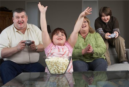 fat person arms up - Family Playing Video Game with Popcorn Stock Photo - Rights-Managed, Code: 700-01345027