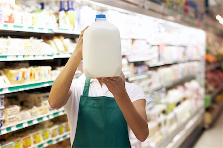 Grocery Clerk Holding Milk Jug Foto de stock - Con derechos protegidos, Código: 700-01345706