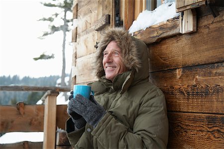 person in gloves holding cup of hot cocoa - Man Drinking Hot Chocolate in Winter Stock Photo - Rights-Managed, Code: 700-01407316