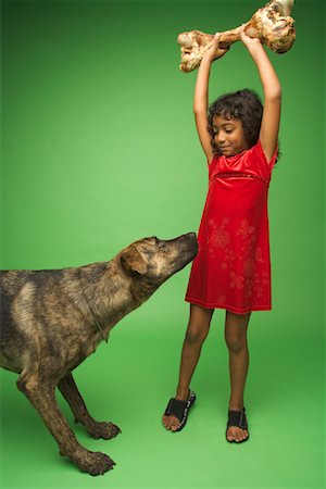 Girl Holding Big Bone for Dog Stock Photo - Rights-Managed, Code: 700-01429188