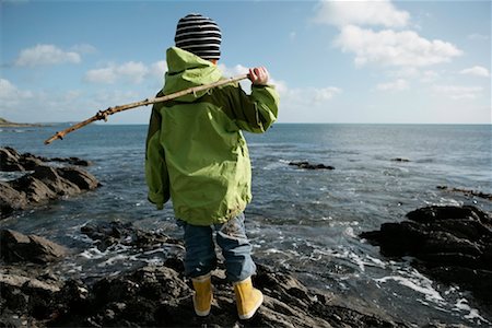 stone in shoe - Child Looking at Ocean from Rocky Shore, England Stock Photo - Rights-Managed, Code: 700-01464581