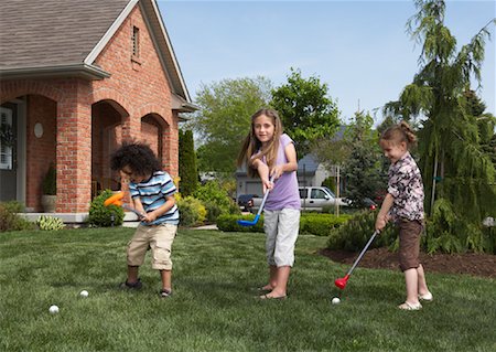 suburban family lifestyle - Children Golfing on Lawn Stock Photo - Rights-Managed, Code: 700-01494599