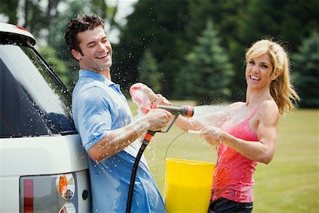 Couple Having Water Fight Foto de stock - Con derechos protegidos, Código: 700-01519518