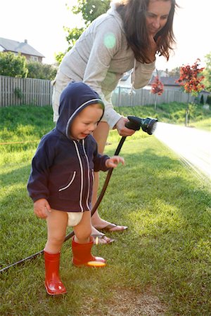 family watering lawn - Mother and Son Watering Grass Stock Photo - Rights-Managed, Code: 700-01519657