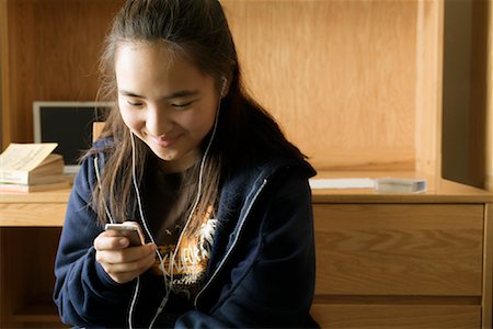 Teenage Girl Listening to Mp3 Player Stock Photo - Rights-Managed, Code: 700-01540879