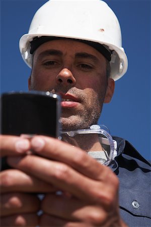 phone in front of face - Portrait of Worker Stock Photo - Rights-Managed, Code: 700-01575530