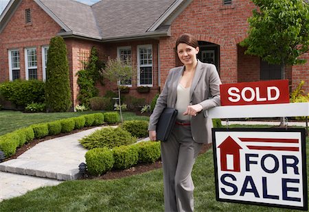 Real Estate Agent by Sold Sign Stock Photo - Rights-Managed, Code: 700-01571946