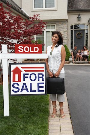 family outside new home - Real Estate Agent by House with Sold Sign Stock Photo - Rights-Managed, Code: 700-01571961