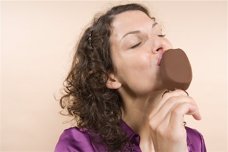 Woman Eating Ice Cream Bar Stock Photo - Rights-Managed, Code: 700-01586130
