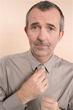 portrait concern adults only studio - Man Adjusting Tie Stock Photo - Rights-Managed, Code: 700-01586246