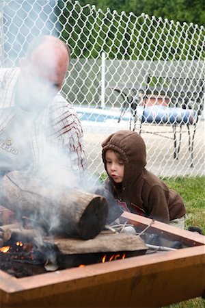family camping fire - Father and Son Starting Campfire Stock Photo - Rights-Managed, Code: 700-01586827