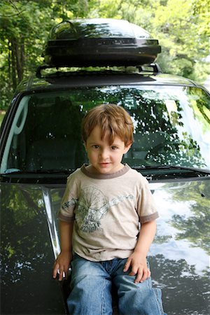 Boy Sitting on Hood of Car Stock Photo - Rights-Managed, Code: 700-01586831