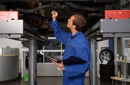 simsearch:700-00430285,k - Mechanic Looking Under Vehicle Stock Photo - Rights-Managed, Code: 700-01587053