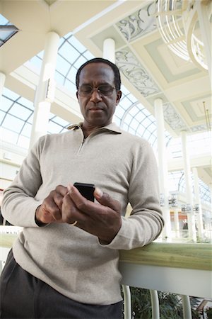 Man at the Mall, Holding Cell Phone Stock Photo - Rights-Managed, Code: 700-01594053