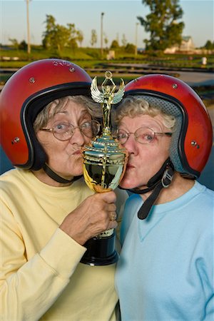 Women Kissing Trophy Stock Photo - Rights-Managed, Code: 700-01595743