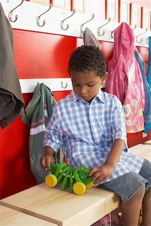 simsearch:614-05523145,k - Boy Playing with Toy by Daycare Coat Rack Stock Photo - Rights-Managed, Code: 700-01593759