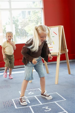 simsearch:6115-06778740,k - Children Playing Hopscotch at Daycare Fotografie stock - Rights-Managed, Codice: 700-01593816