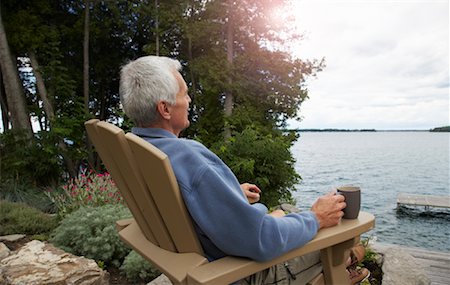 Man in Chair Looking Across Lake Stock Photo - Rights-Managed, Code: 700-01606181