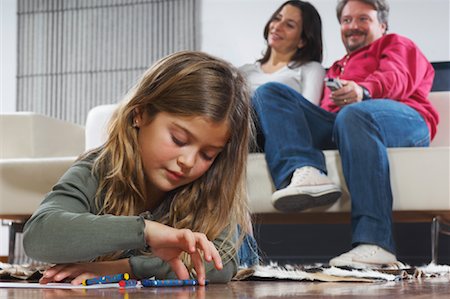 simsearch:614-03784139,k - Little Girl Drawing, Parents Watching Television in Background Stock Photo - Rights-Managed, Code: 700-01606640
