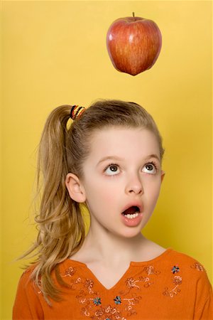 Girl Looking at Apple Stock Photo - Rights-Managed, Code: 700-01607050