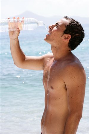 Man with Water Bottle on Beach, Dodecanese, Greece Stock Photo - Rights-Managed, Code: 700-01607104