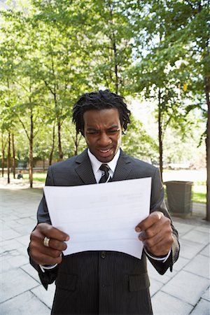 dreadlocks on african americans - Angry Businessman Reading Document Foto de stock - Con derechos protegidos, Código: 700-01615236