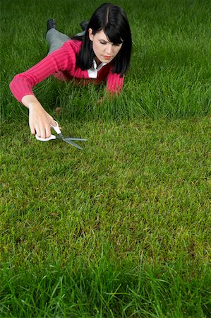 Woman Cutting Grass With Scissors Foto de stock - Con derechos protegidos, Código: 700-01633296