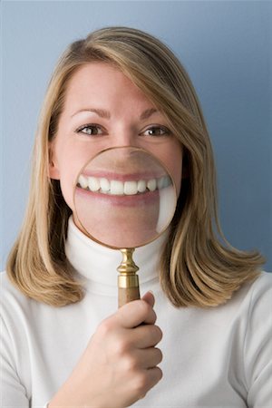 Woman Holding Magnifying Glass in Front of Face Fotografie stock - Rights-Managed, Codice: 700-01646268